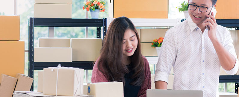 Two small business owners working on a laptop