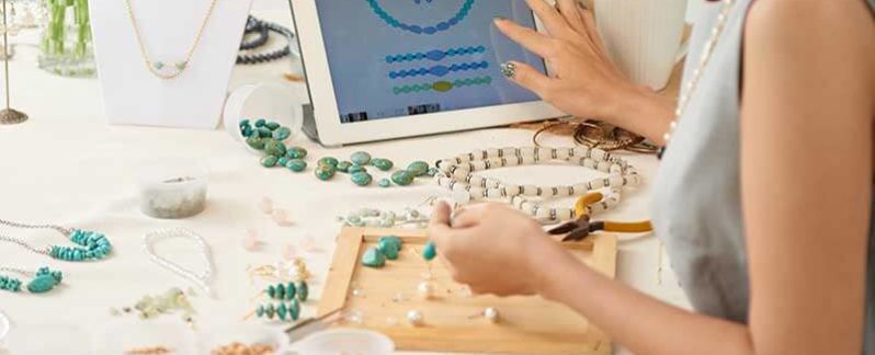 Woman making beaded jewelry.