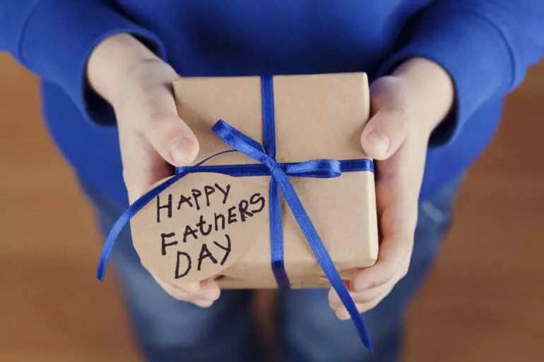 Person holding Father's Day gift.
