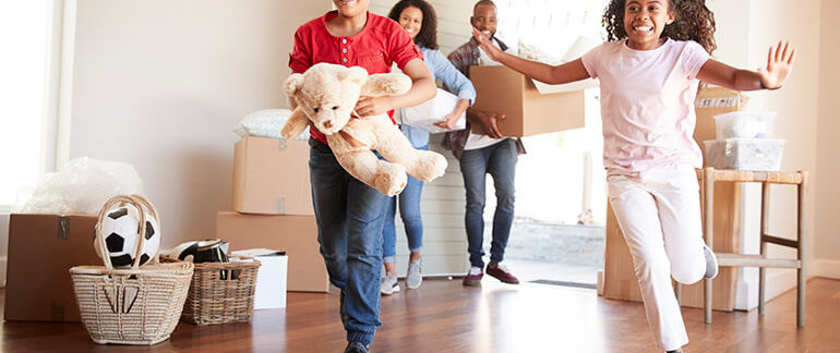 Family moving boxes into their new house.