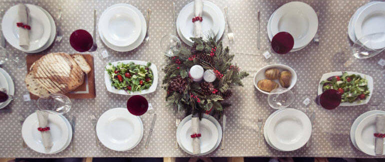 A table adorned with trays of holiday food.