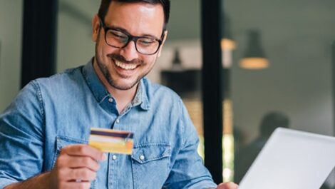 Man looking at his credit card.