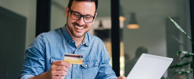 Man looking at his credit card.