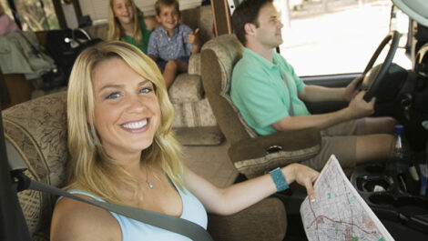 A family rides along the highway in their RV