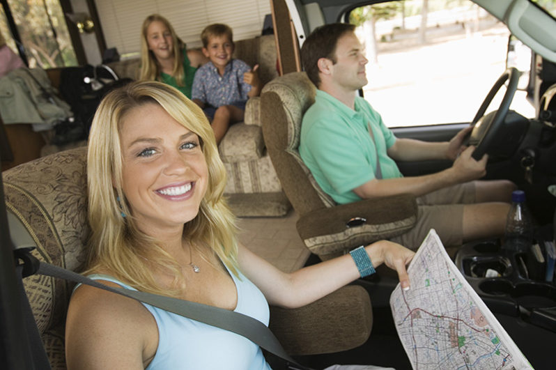 A family rides along the highway in their RV