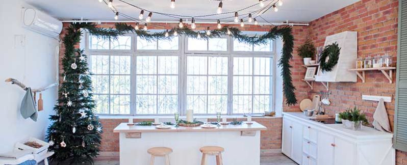 view of a kitchen decorated with lights and a Christmas tree