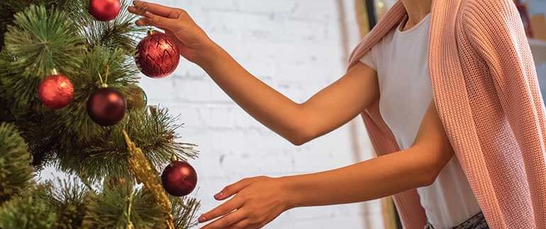 A woman taking down holiday decorations
