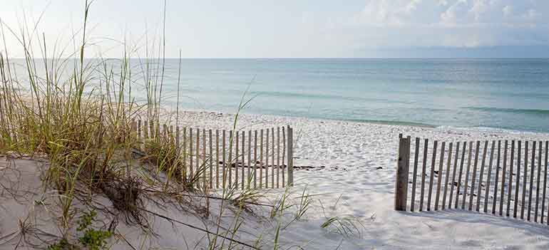 Beautiful Florida white sandy beach with fenced opening