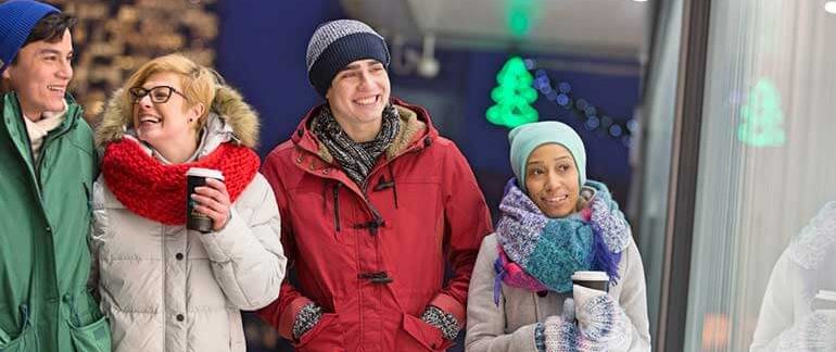 A group of people walk around Chicago bundled up in warm clothing