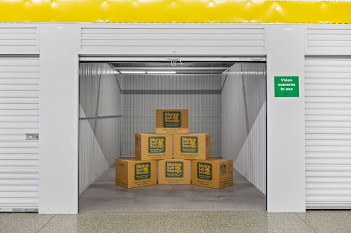 Branded Metro Self Storage boxes in an open storage unit.