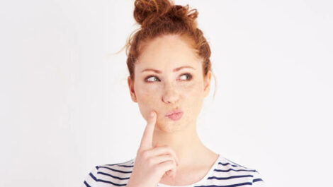 Woman deciding whether to upsize or downsize her storage unit.