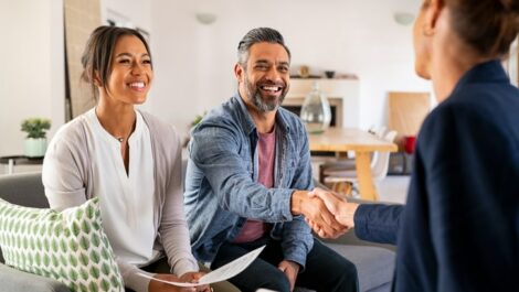 Buyer and realtor smiling and shaking hands