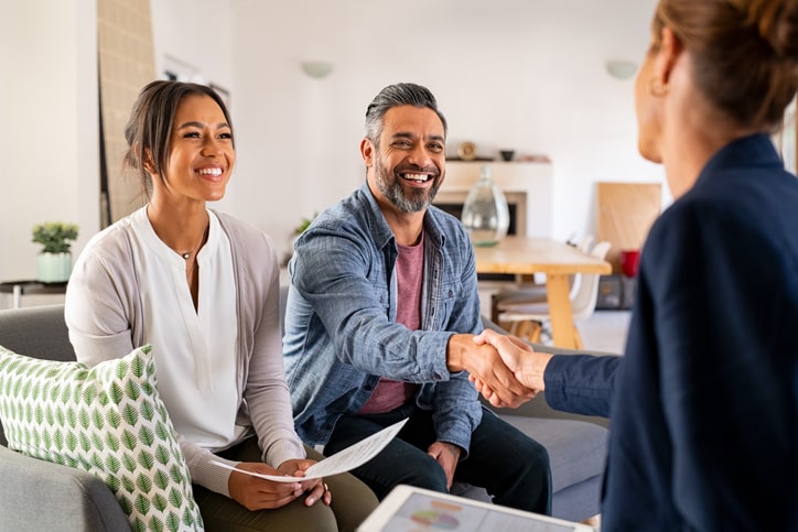 Buyer and realtor smiling and shaking hands