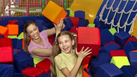 Mother and daughter play in foam pit