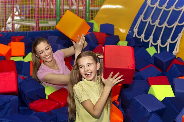 Mother and daughter play in foam pit