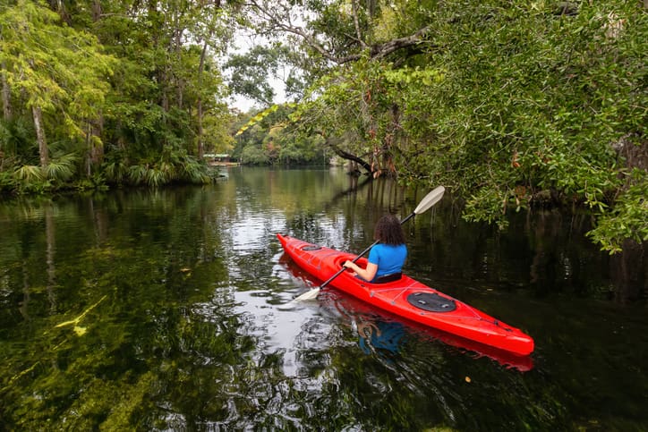 Woman kayaking down Weeki Wachee River