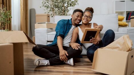 Couple sitting close together while looking at photos