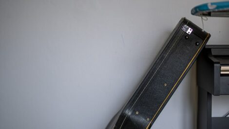 guitar cases stacked against each other against the wall