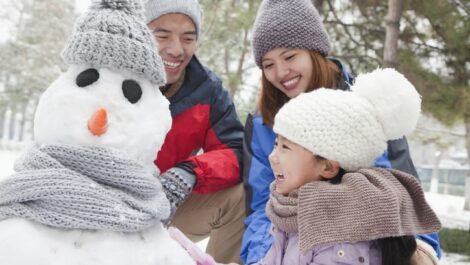Happy family building a snowman