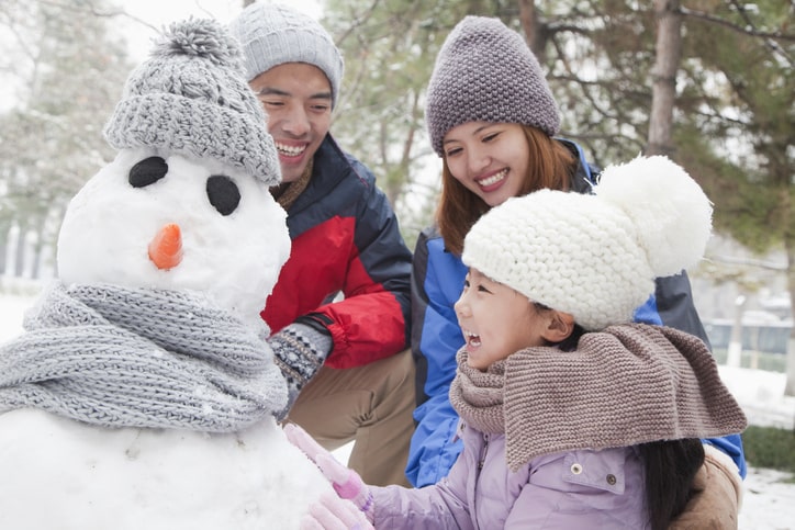 Happy family building a snowman