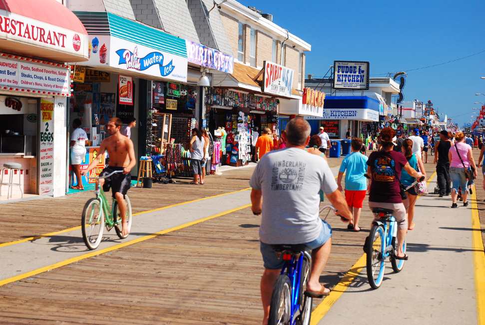 People biking down the Jersey Shore Boardwalk
