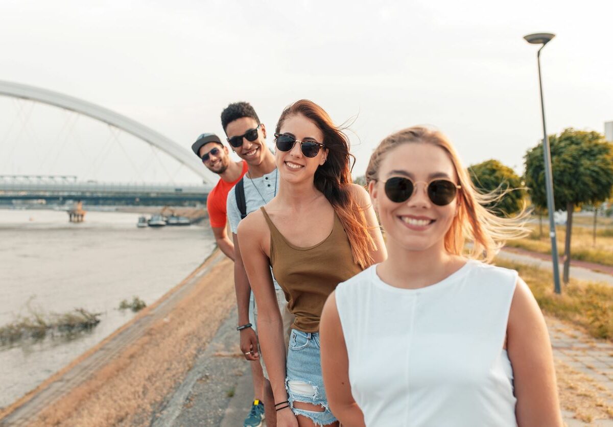 A photograph of happy young adults wearing sunglasses