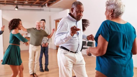 Group of elderly people dancing together at a party.
