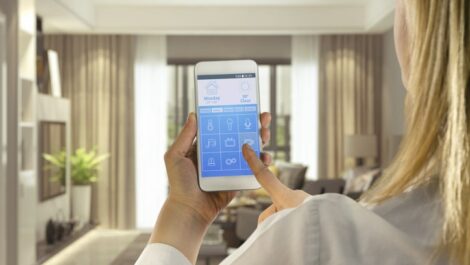 Woman using smart home app on phone