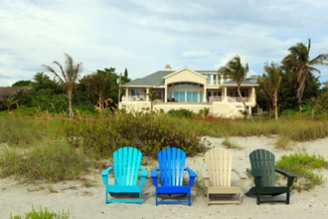 Four chairs in front of beachhouse